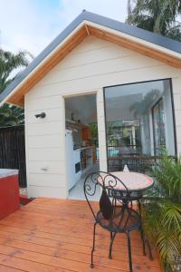 a patio with a table in front of a house at The Esplanade Motel in Lakes Entrance
