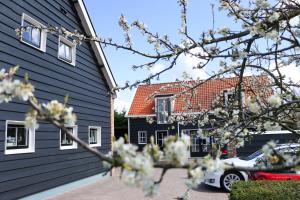 
a car is parked in front of a house at Oostmolenhoeve B&B in Goes

