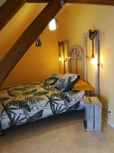 a bedroom with a bed in a room at Les Gites de la Musardière in Meusnes
