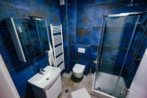 a bathroom with a toilet and a shower and a sink at Delux Apartmani Bulevar in Sarajevo +31 photos