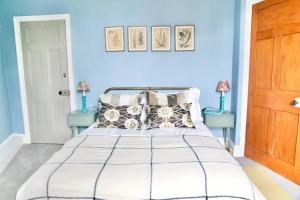 a blue bedroom with a bed with two blue tables at The View in Bowness-on-Windermere