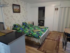 a bedroom with a bed and a table in it at Bori Apartmanok in Hajdúszoboszló
