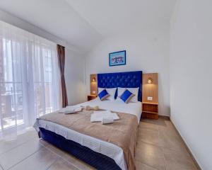- une chambre avec un grand lit et une grande fenêtre dans l'établissement Apartments Pedja Zec, à Budva