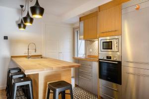 a kitchen with a counter and a sink and a stove at Casa Oso in Panticosa