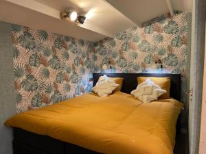 Säng eller sängar i ett rum på Tiny House de Eikhof