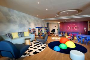 a childrens room with a big with chairs and a table at Palladium Hotel Menorca in Arenal d'en Castell