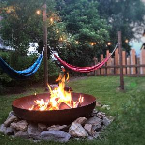 a fire pit with hammocks in a yard at Gasthof Auwirt in Sankt Michael im Lungau