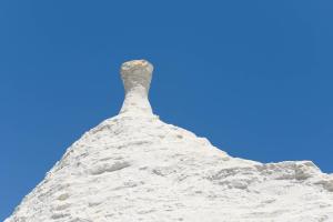 a pile of snow with a blue sky in the background at Charming Villas with Pool in Valle d'Itria in Ostuni