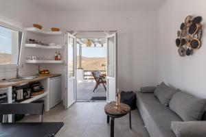 a living room with a couch and a table at Miramare Suites Mykonos in Merchia Beach