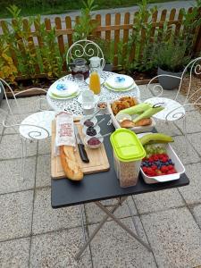a table with food and drinks and a tray of food at La Vieille Grange - NOUVEAU - in Saint-Privat-des-Prés