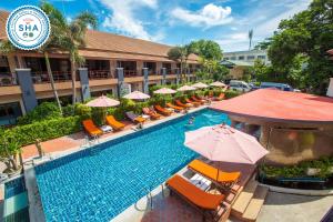 an overhead view of a hotel pool with chairs and umbrellas at Sunrise Resort- Koh Phangan - SHA Extra Plus in Haad Rin