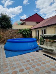a blue trampoline in a yard with a bench at Apart Hotel Sayat-Nova in Vanadzor