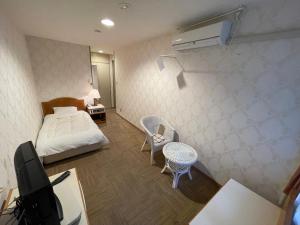 Postel nebo postele na pokoji v ubytování Hotel Ginsui