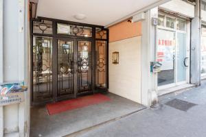 a door to a store with a red rug in front at G&C house in Rome