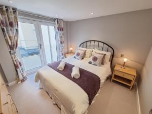 a bedroom with a bed and a large window at The Danbury, Lower Borough Walls in Bath