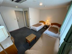Postel nebo postele na pokoji v ubytování Hotel Ginsui