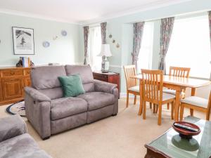 a living room with a couch and a table at Ellan Vannin in Sheringham