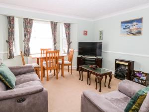 a living room with a couch and a table at Ellan Vannin in Sheringham