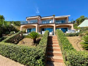 a house with a staircase in front of it at Bellavista di Magarà in Cefalù