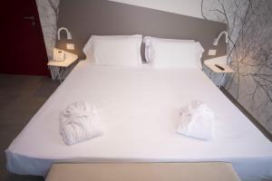 Posteľ alebo postele v izbe v ubytovaní Hotel Malavoglia