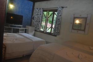 Cama ou camas em um quarto em Pousada Baobá