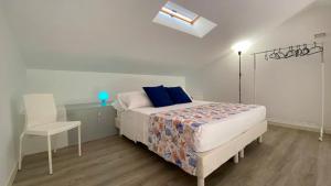a bedroom with a bed and a table and a chair at Bellavista di Magarà in Cefalù