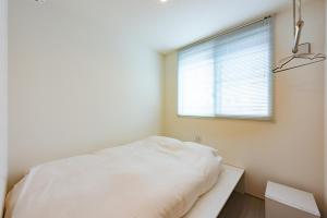 Postel nebo postele na pokoji v ubytování plat hostel keikyu sapporo sky
