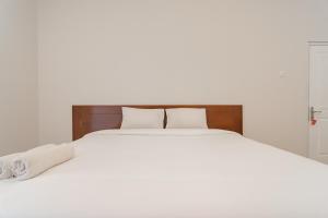 Un pat sau paturi într-o cameră la Rossan Villa Hotel near Kampus UPI Setiabudhi