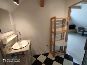 a bathroom with a sink and a shelf next to a mirror at Gosciniec Wydminy in Wydminy +65 photos