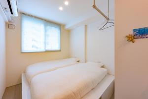 Postel nebo postele na pokoji v ubytování plat hostel keikyu sapporo sky