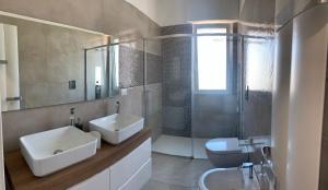 a bathroom with a sink and a toilet and a shower at MERAVIGLIOSO in Polignano a Mare