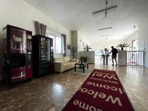 a person walking through a room with a soda machine at Ubytovňa Milex in Nové Mesto nad Váhom