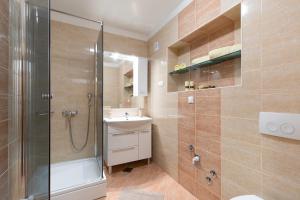 a bathroom with a shower and a toilet and a sink at Apartments Tonica in Malinska +36 photos