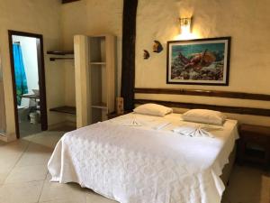 Cama ou camas em um quarto em Pousada Baobá mais 25 fotos