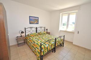 Postel nebo postele na pokoji v ubytování Residence Punta Pizzo