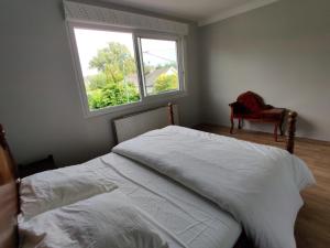 - une chambre avec un lit blanc et une fenêtre dans l'établissement Pilets de la baie d'Authie, à Fort-Mahon-Plage