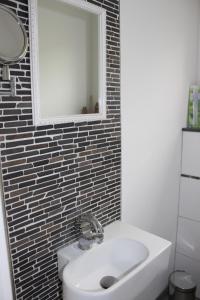 a bathroom with a sink and a mirror at FeWo Auszeit in Rieden