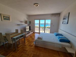 a bedroom with a bed and a table and a dining room at Villa Luciana in Trogir +50 photos