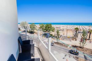 a balcony with a view of the beach and the ocean at Hotel Baby in Rimini