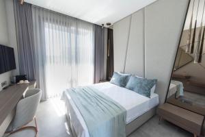 a bedroom with a bed and a large window at Enso Alaçatı in Çeşme +55 photos