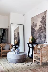 a living room with a coffee table and two chairs at Richmond Studios in Melbourne