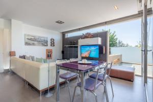a living room with a table and a couch at Villa Zoe in Palma de Mallorca