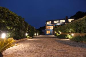 a house with a driveway at night with lights at Mega Ocean Magoito - Sintra in Sintra
