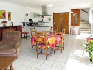 a kitchen and dining room with a table and chairs at Holiday Home Ty Kerzo - PHM100 by Interhome in Plouhinec