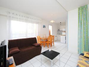 a living room with a couch and a table at Studio PORT SUD by Interhome in Capbreton