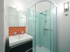 a bathroom with a sink and a glass shower at Studio PORT SUD by Interhome in Capbreton