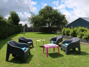 a group of chairs and a table in the grass at Holiday Home Ty Manolo - TGX100 by Interhome in Tregueux