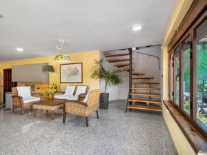 a living room with a table and chairs and a staircase at Villa El Balcon by Interhome in Baena +31 photos