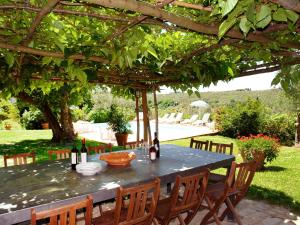 einen Tisch mit Weinflaschen unter einer Pergola in der Unterkunft Holiday Home Bulleri by Interhome in San Casciano in Val di Pesa