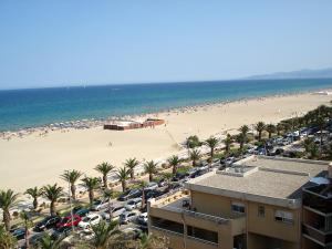 a view of a beach with a lot of cars at Apartment Soleil Bleu-8 by Interhome in Canet-en-Roussillon